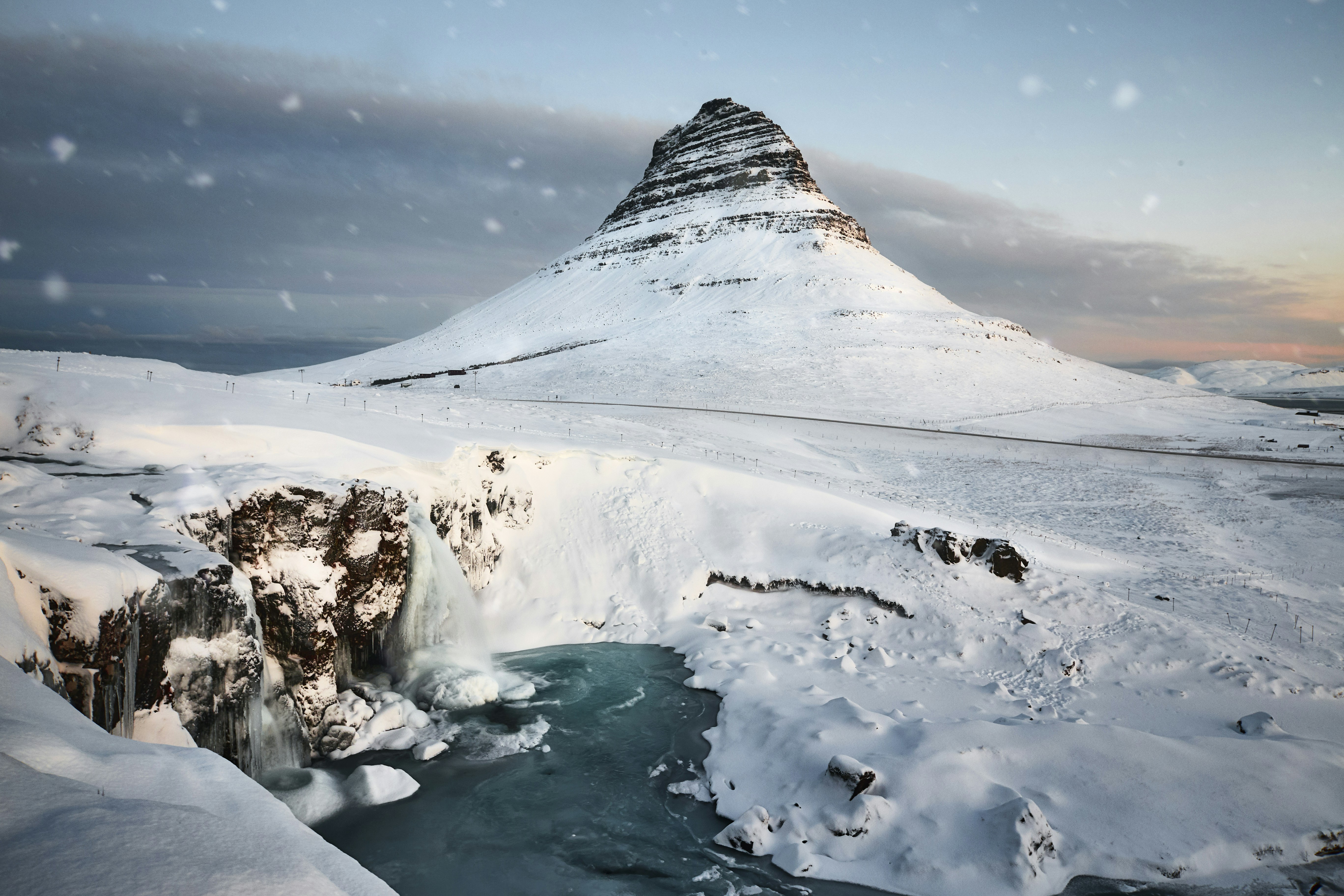 kirkjufellfoss in Iceland covered with snow during daytime