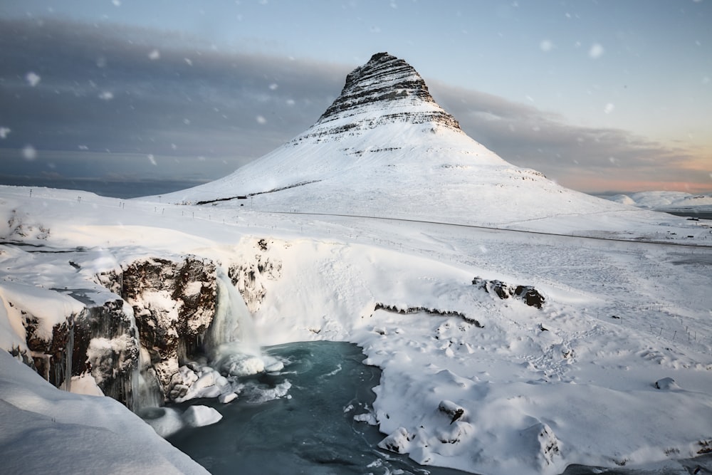 kirkjufellfoss in Iceland covered with snow during daytime