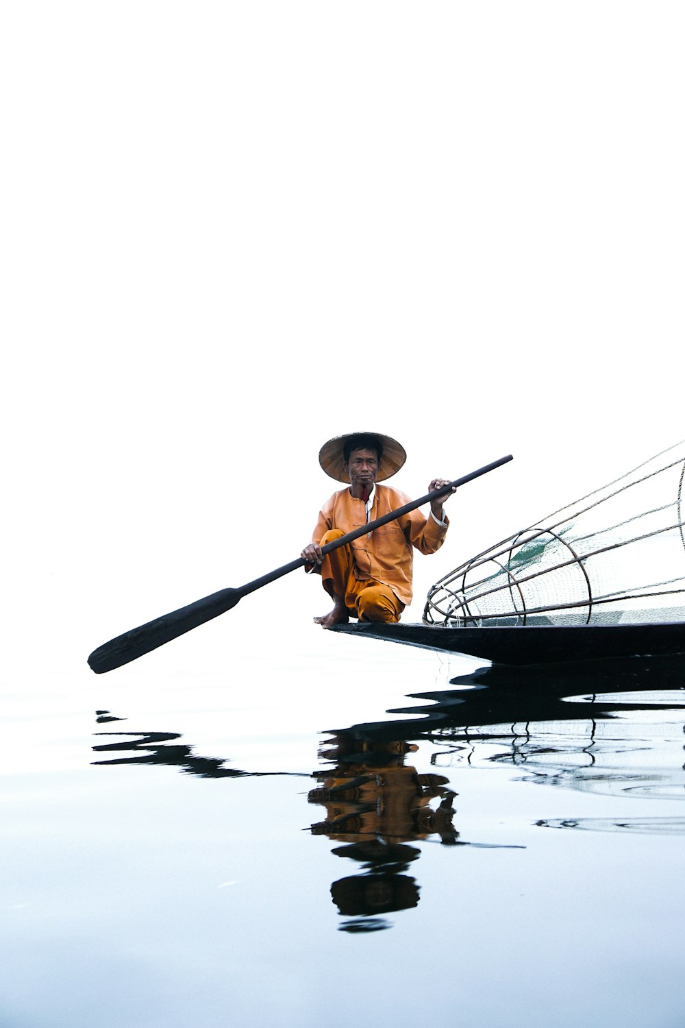 man on boat holding paddle