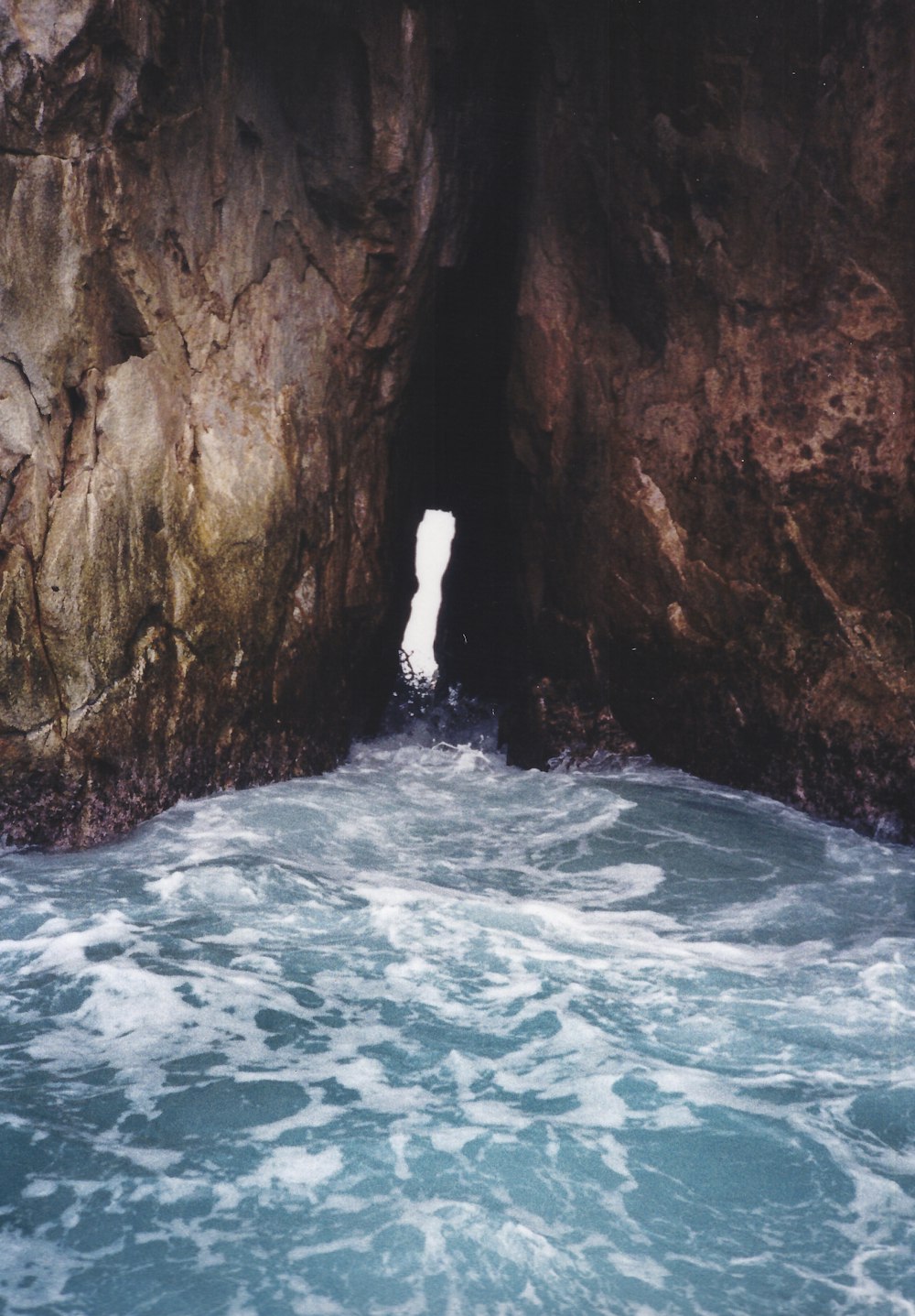 body of water under cave