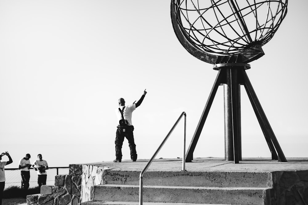 man standing near metal structure