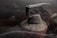 A dusty fire extinguisher shrouded in intricate cobwebs, suggesting long-term neglect. The ambient lighting is dim, creating a sense of abandonment and mystery.