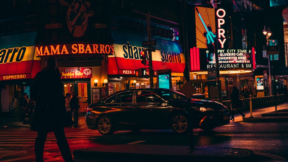 black sedan on road at night