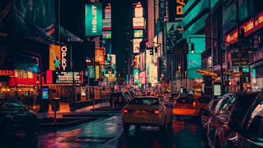 cars on road surrounded by building during nighttime