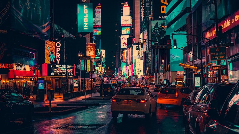 cars on road surrounded by building during nighttime