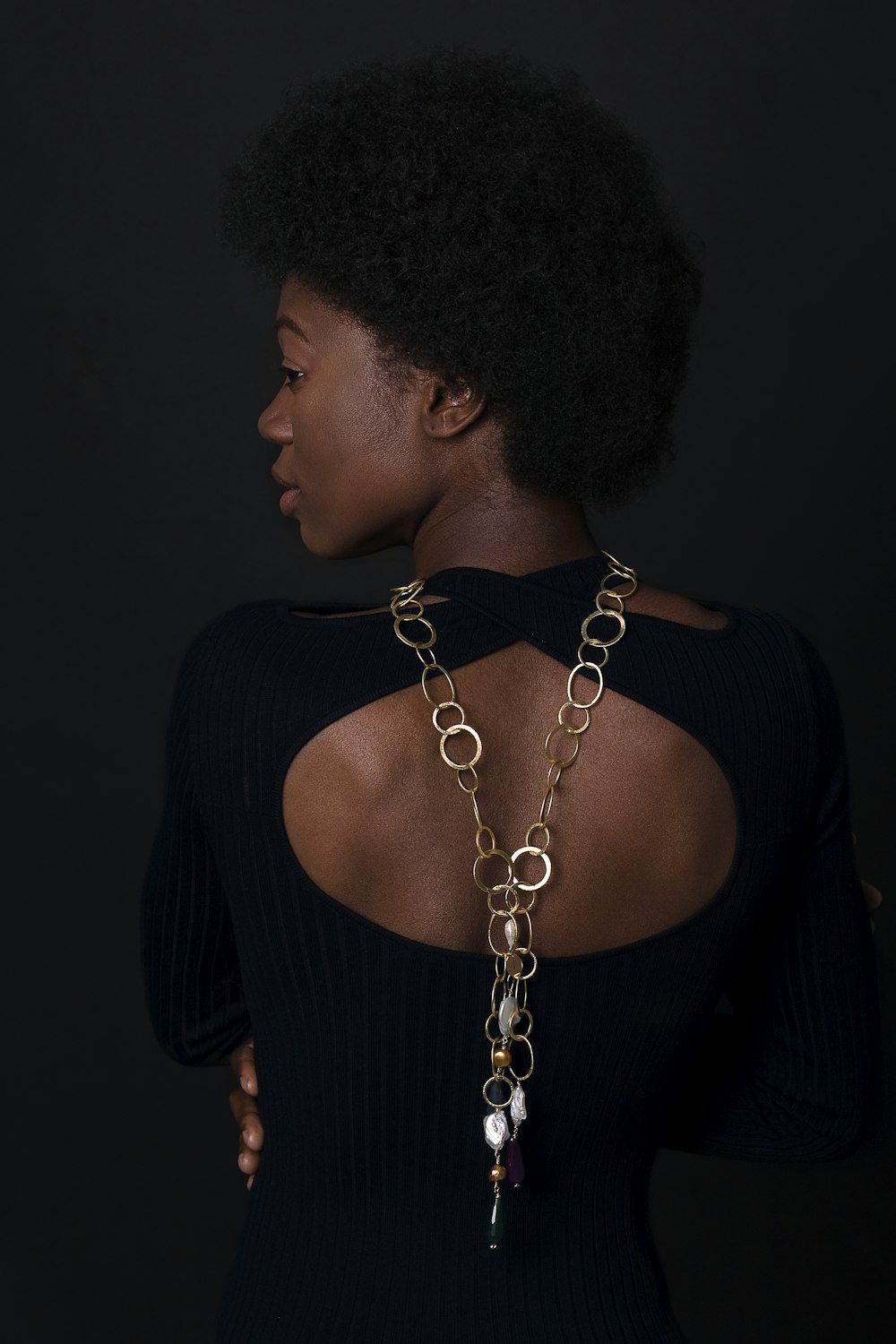 woman in black dress with silver-colored necklace