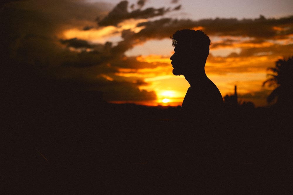 man's silhouette during sunset