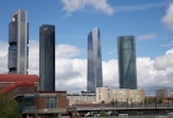 A panoramic view of the modern skyline of Madrid with clear blue skies.