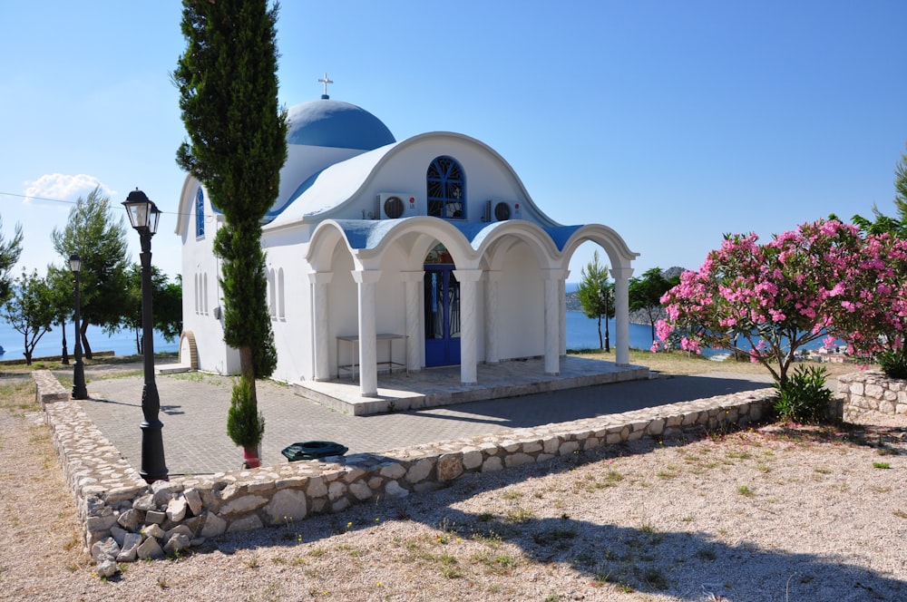 blue dome and white house near sea during daytime