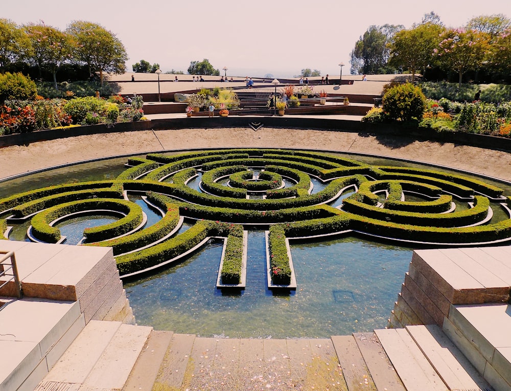 a large circular garden with a fountain in the middle