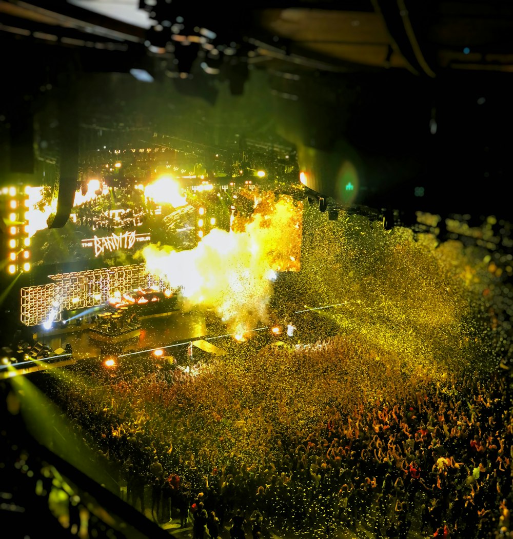 band playing on stage front of crowd during nighttime