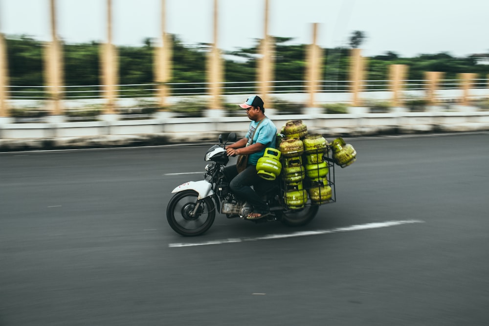 man riding motorcycle with propane tanks
