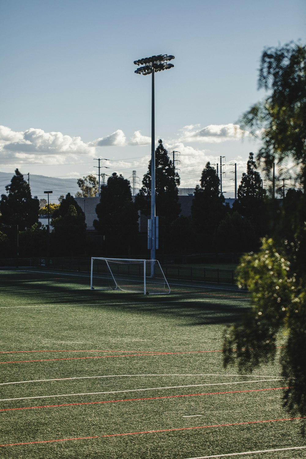 white soccer field post lights during daytime