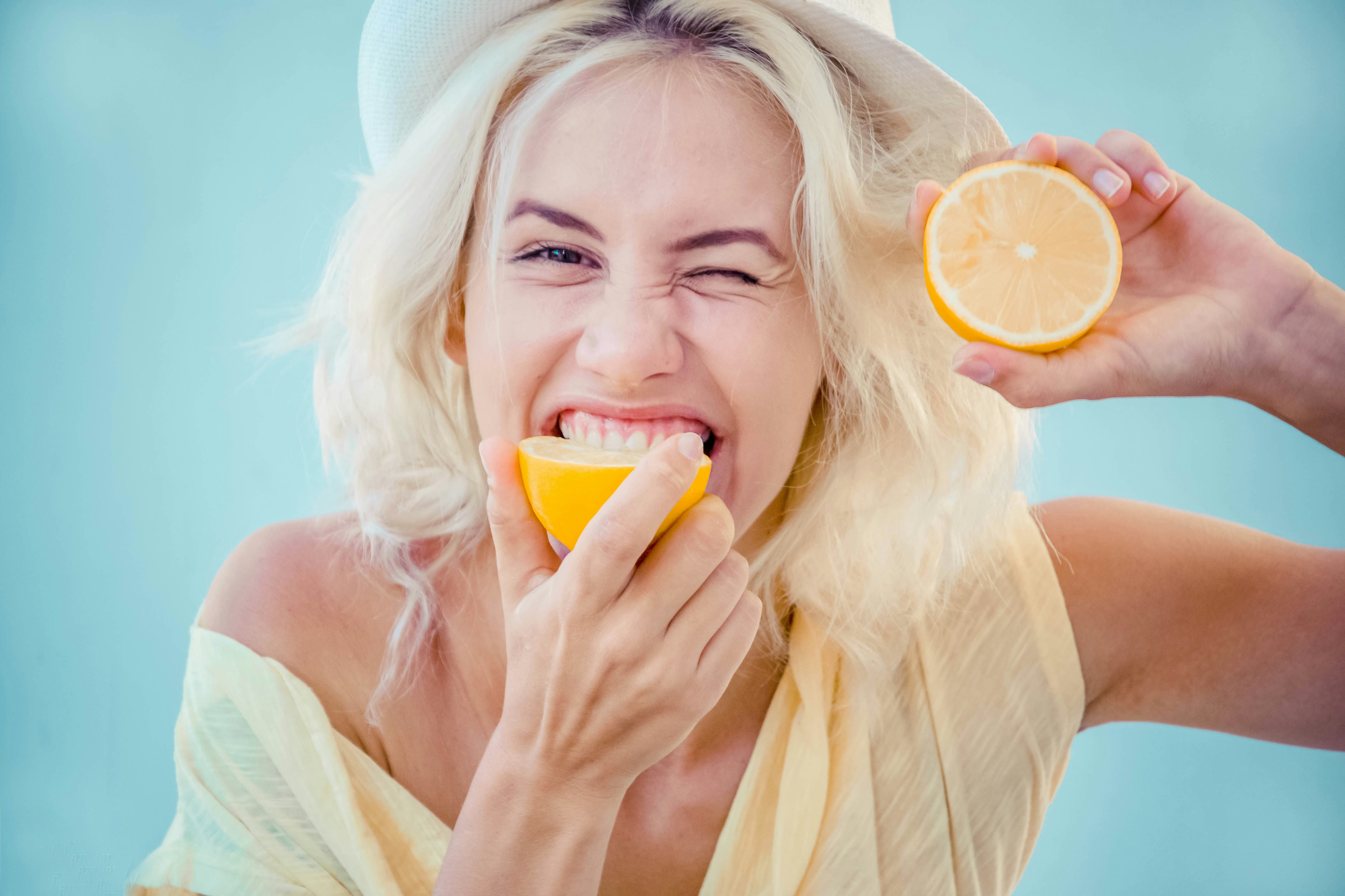 woman biting lemon
