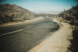 A panoramic view of a road construction project winding through a desert landscape.