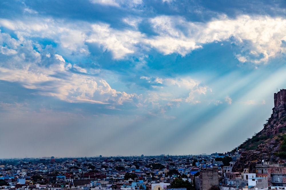 clouds over houses and buildings during daytime