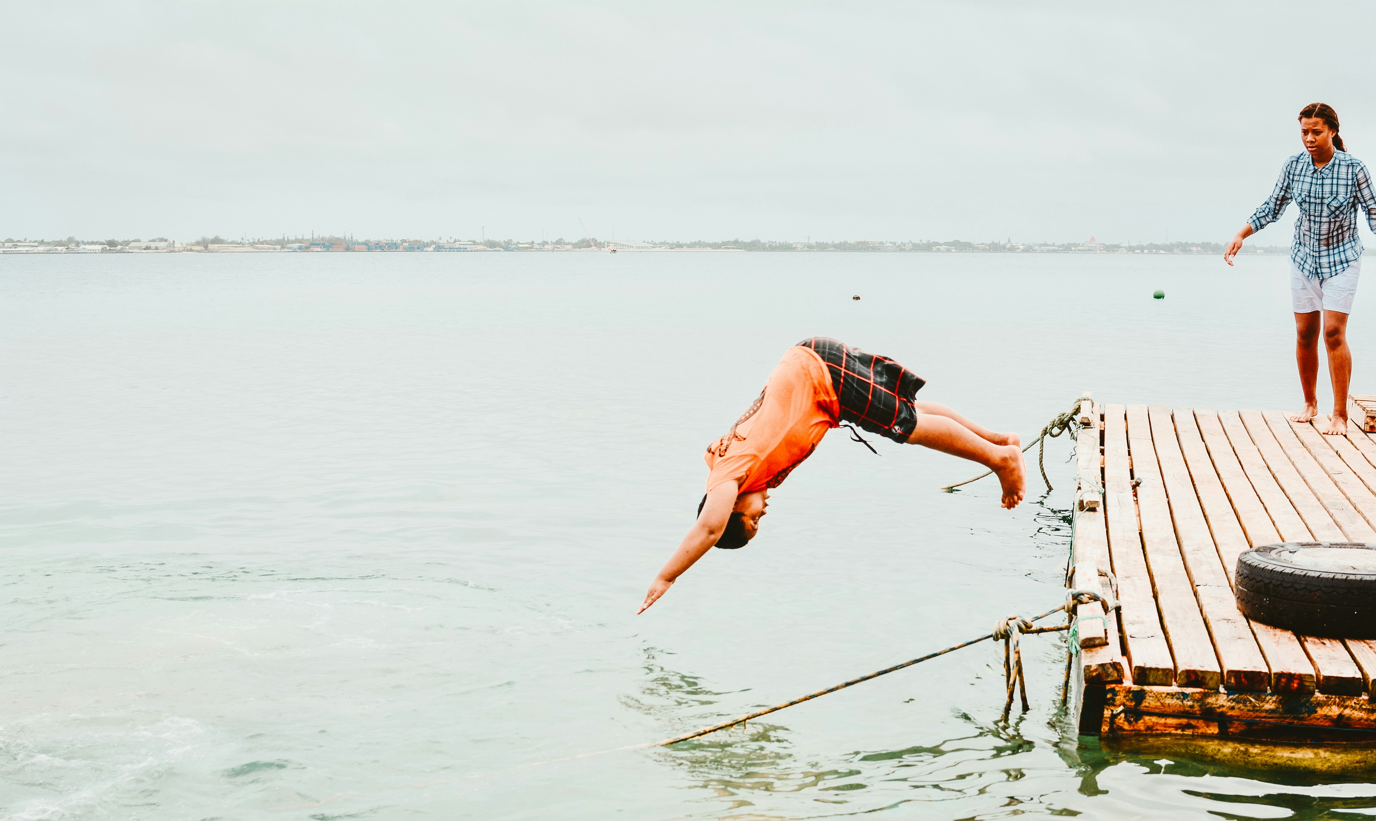 woman diving on water tonga teams background
