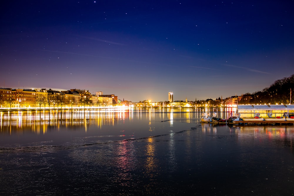 a body of water with boats in it at night