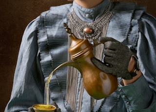 woman holding turkich teapot