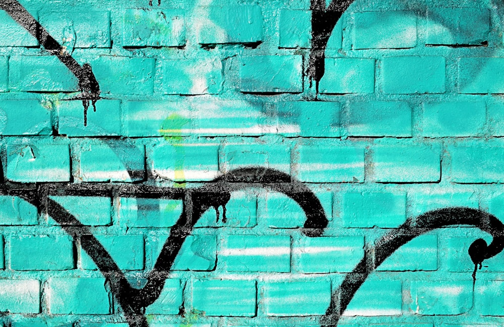 teal and black graffiti wall