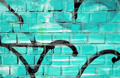 A teal graffiti wall