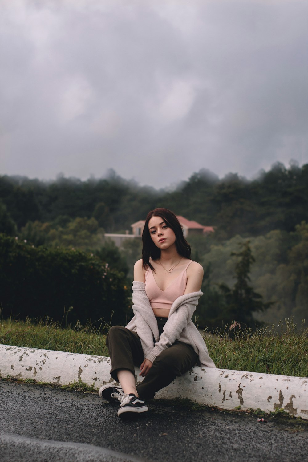 woman sitting beside road