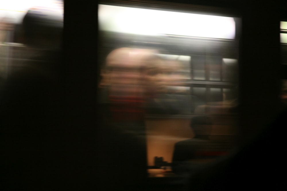 a blurry photo of a woman on a train