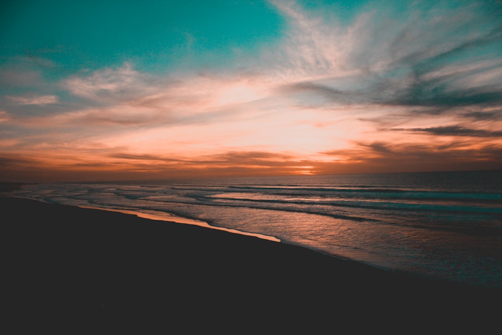 body of water during sunset