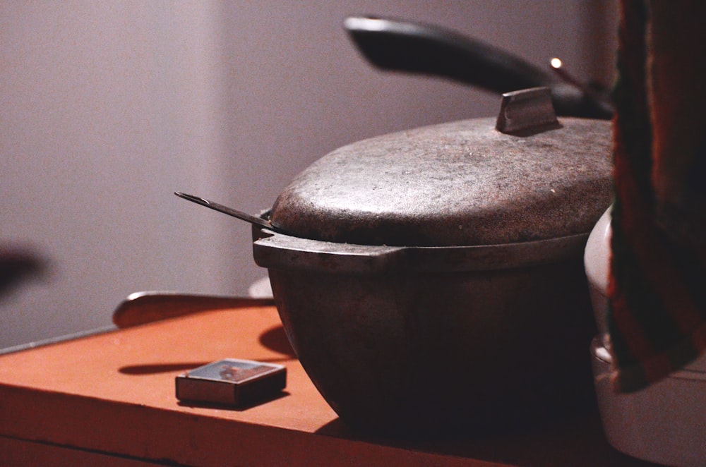 matchbox on table beside grey bowl with lid