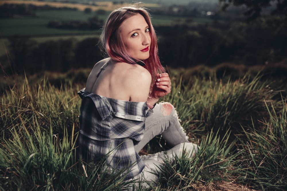 woman sitting on grass field