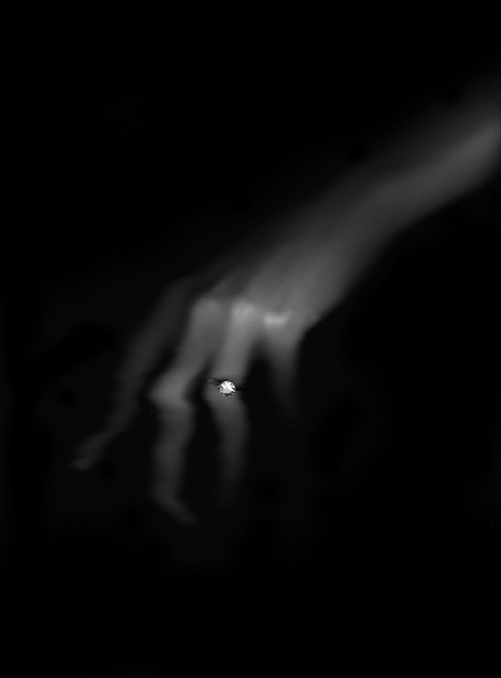 a black and white photo of a person's hand