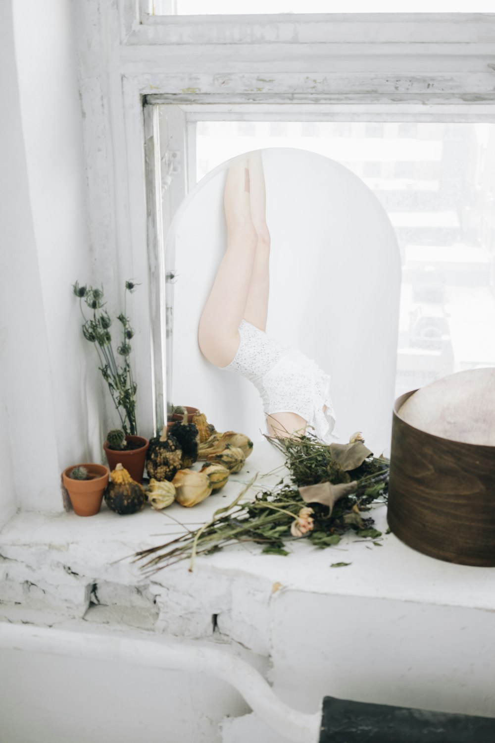 a window sill with a vase and flowers on it