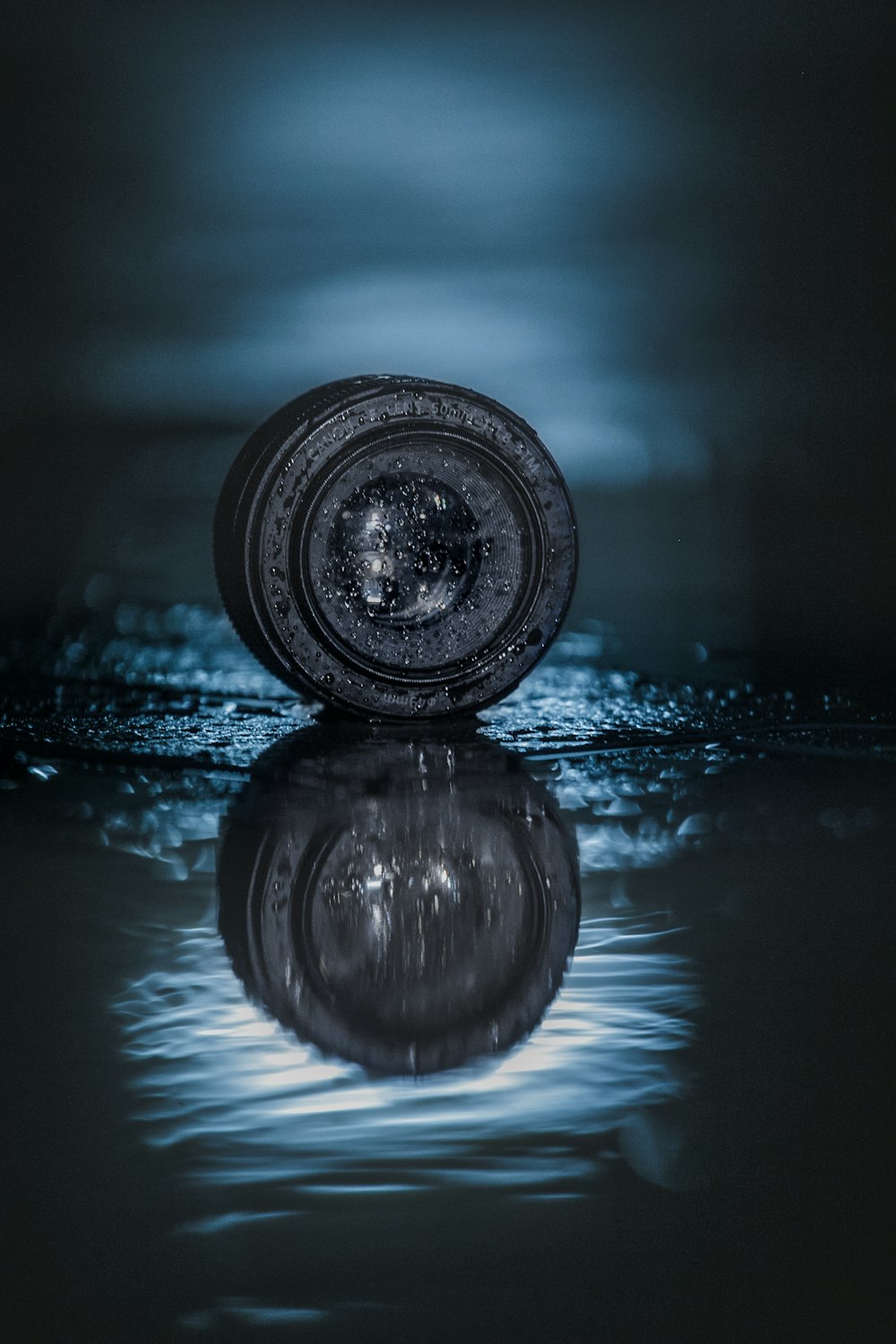 round black smartphone lens with reflection on water digital wallpaper