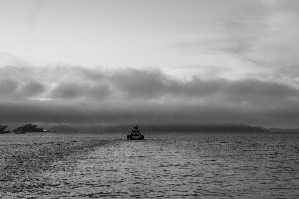 grayscale photo of boat on ocean