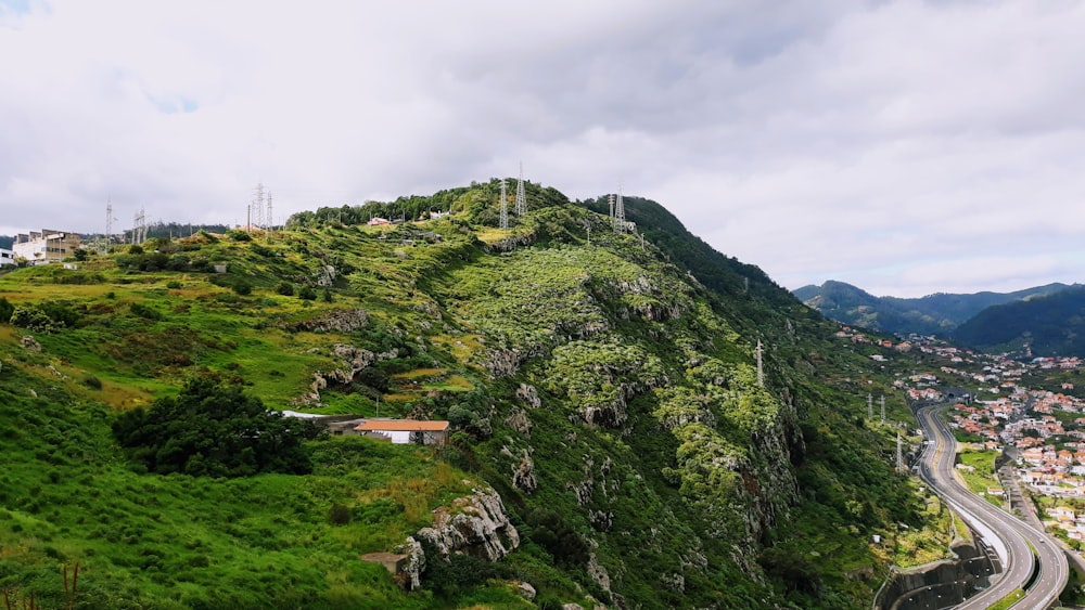 mountain near road under white clouds