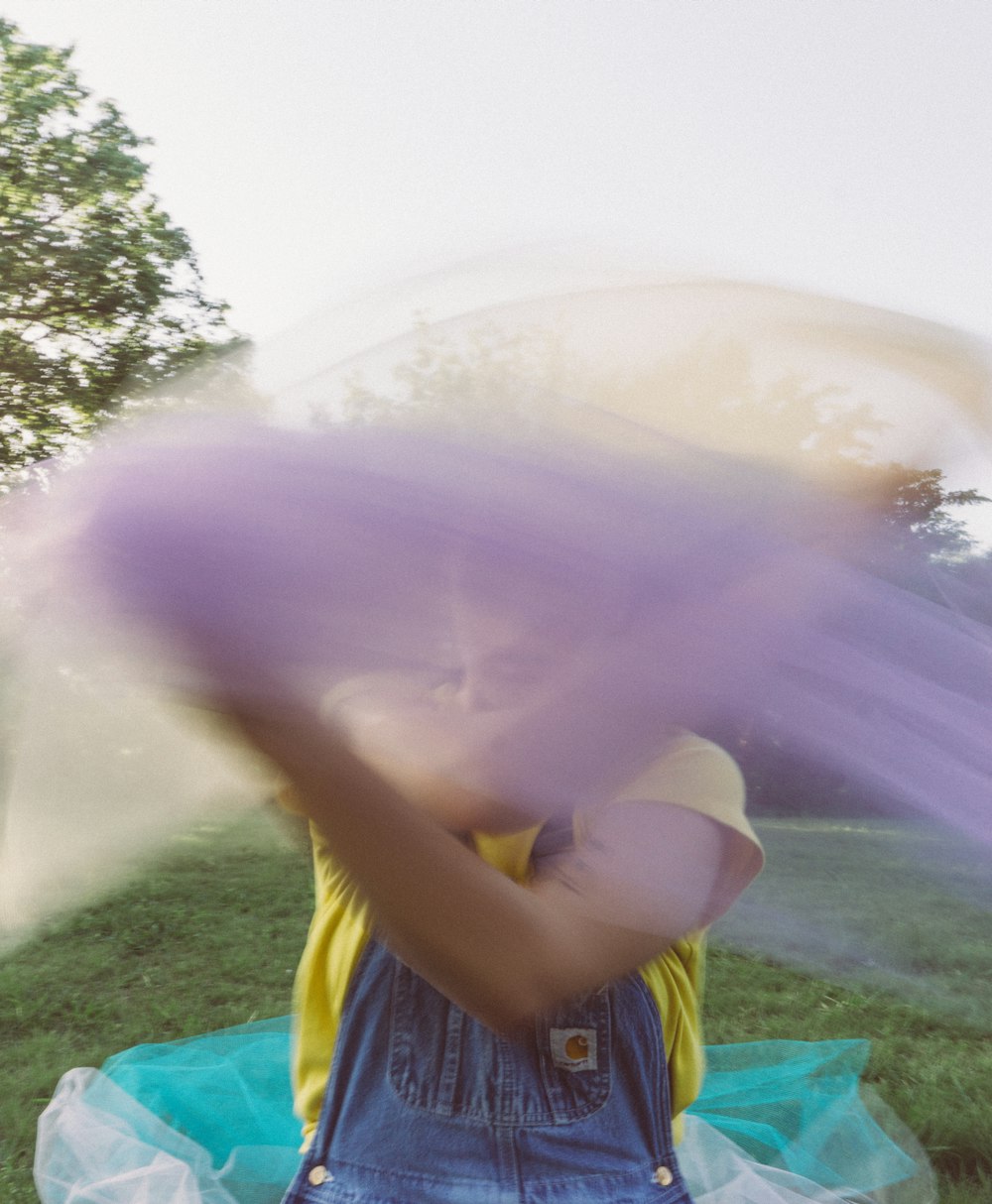 person whipping purple mesh textile