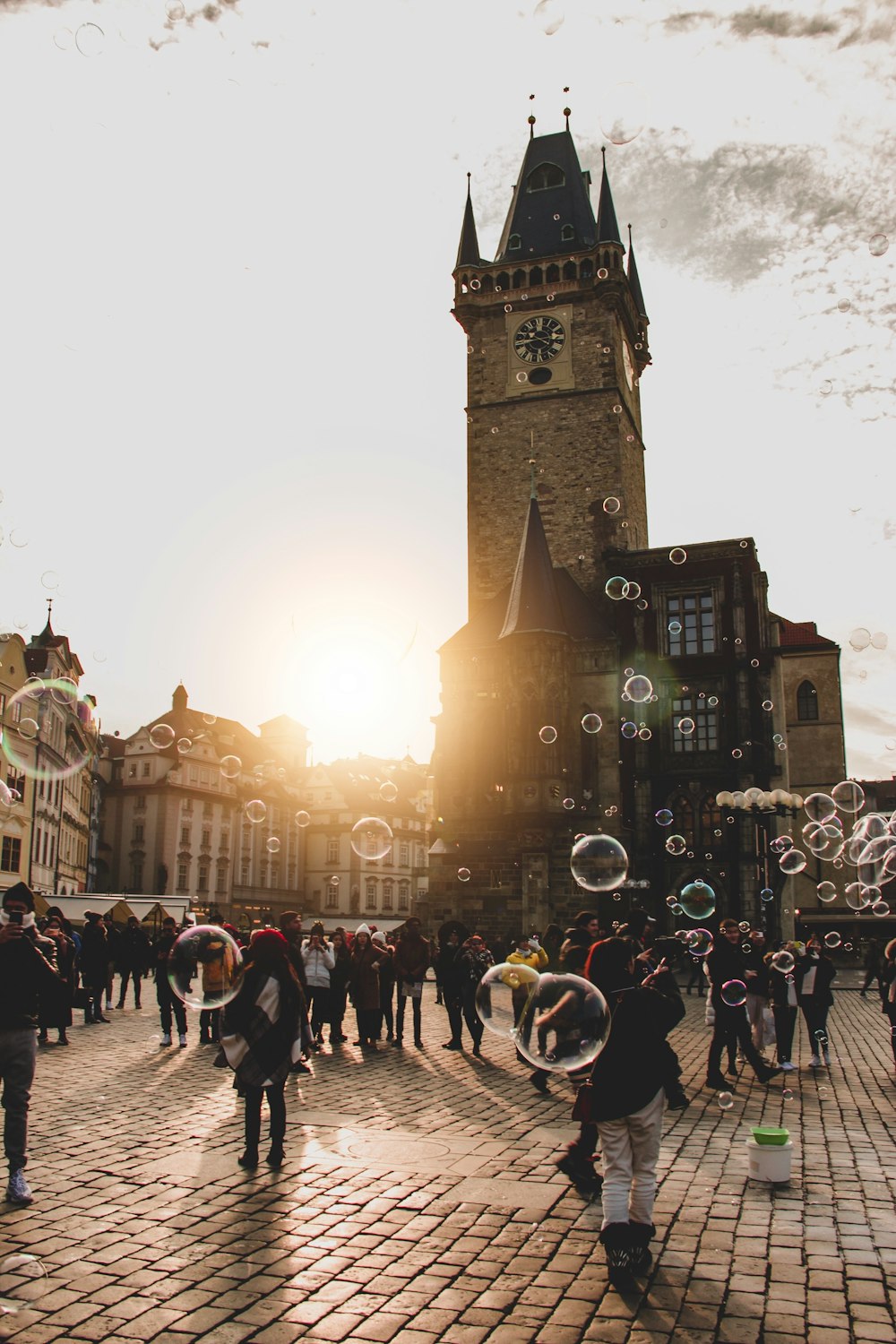 people gathering outdoor with bubbles during daytime