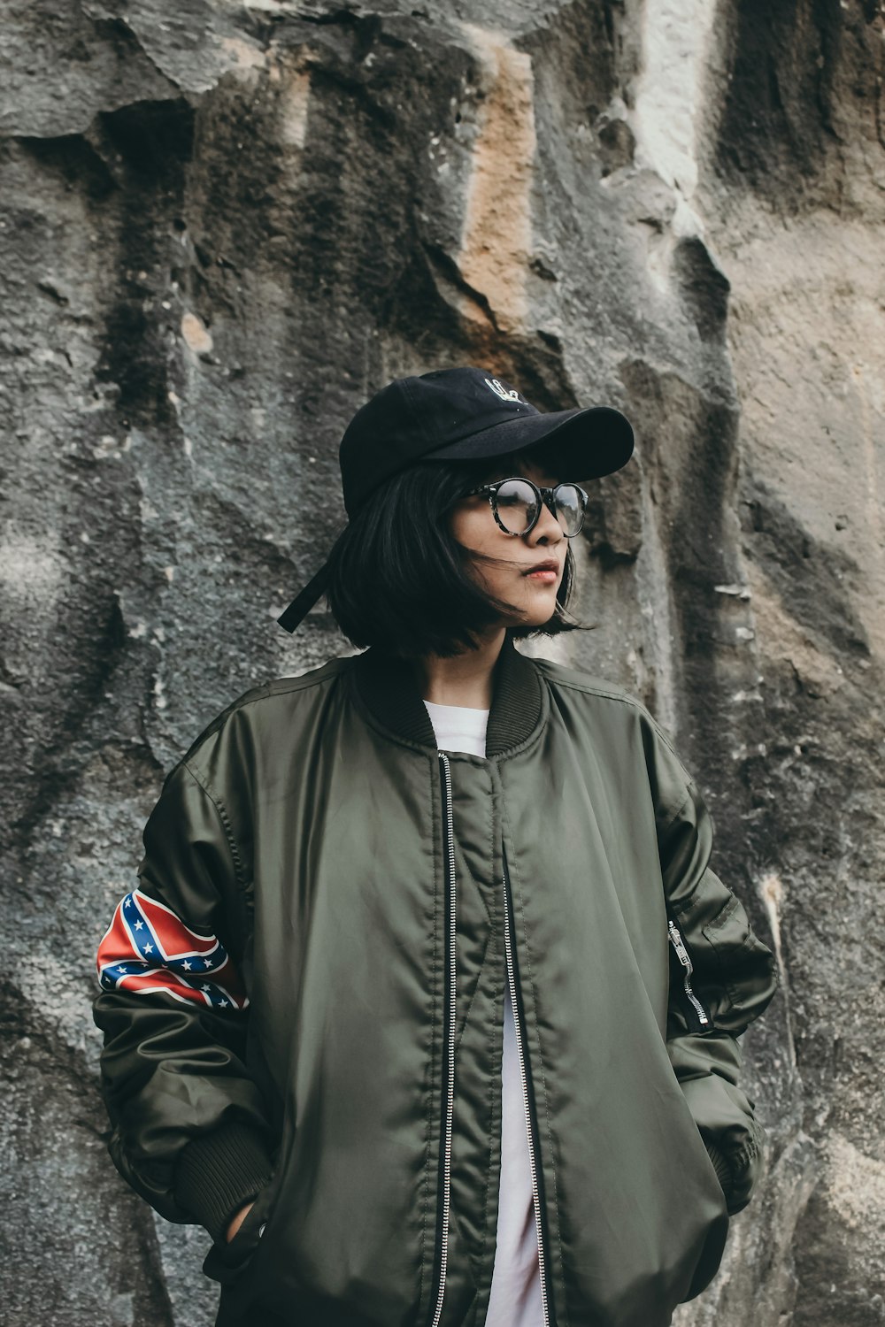 woman wearing gray zip-up jacket and black cap