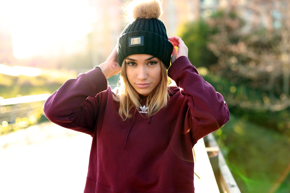 woman wearing black bobble hat standing