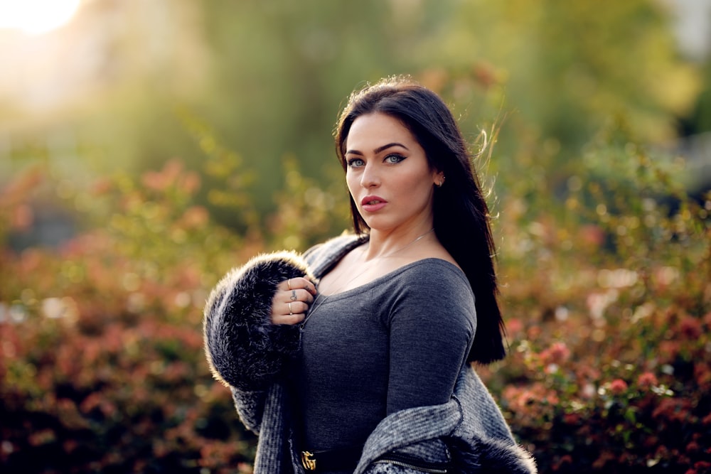 woman standing near flowers during daytime