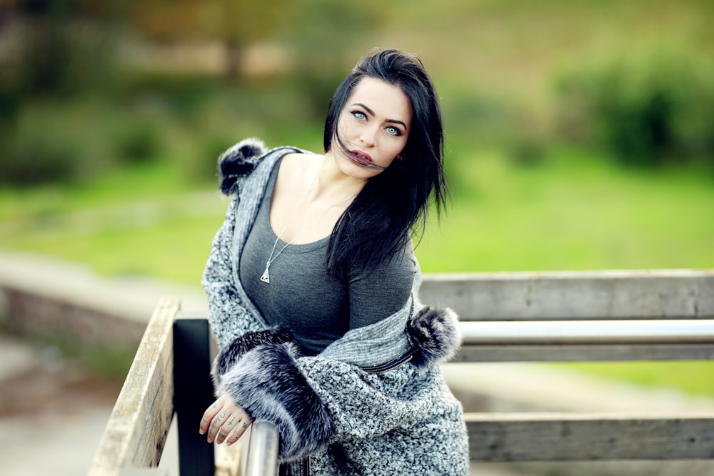 woman in gray coat in selective focus photography