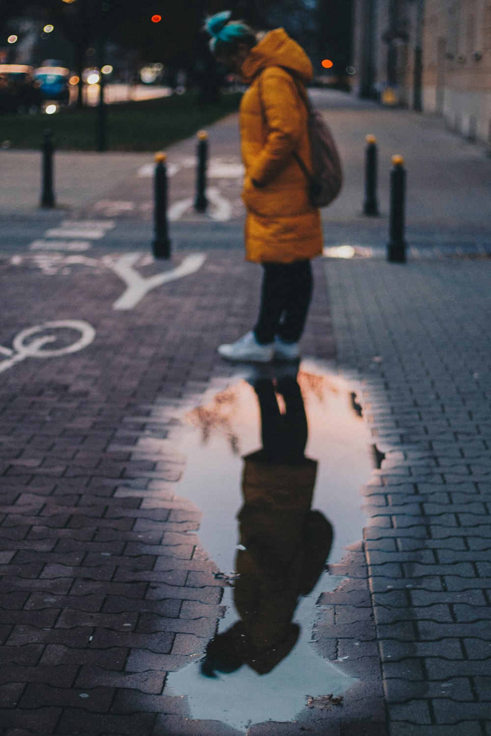 woman standing beside wet road