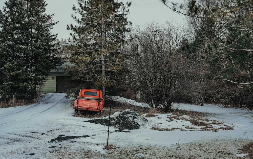 red pickup truck parked beside tree