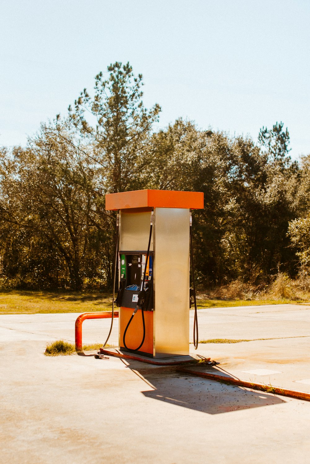 white and orange gas pump during daytime
