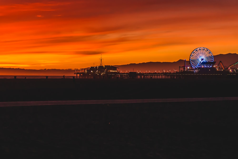 photo of pier and building during golden hour