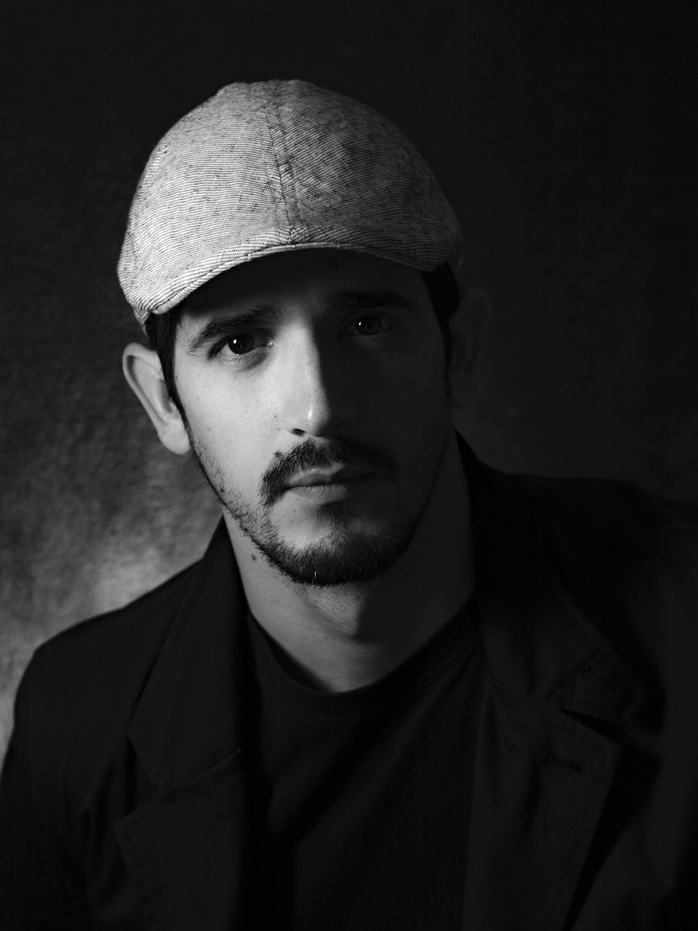 grayscale photo of man wearing hat