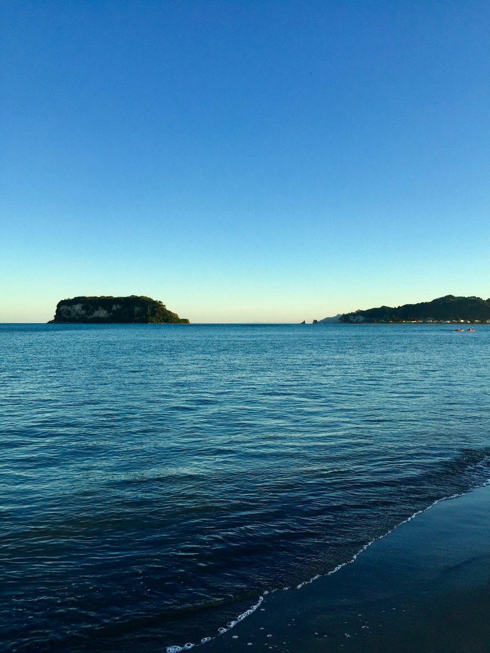 islets under clear blue sky during daytime