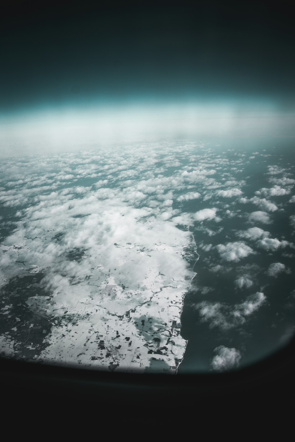plane window overlooking clouds