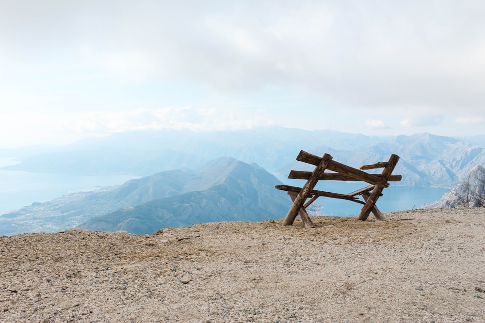 brown wooden bench by the edge of cliff