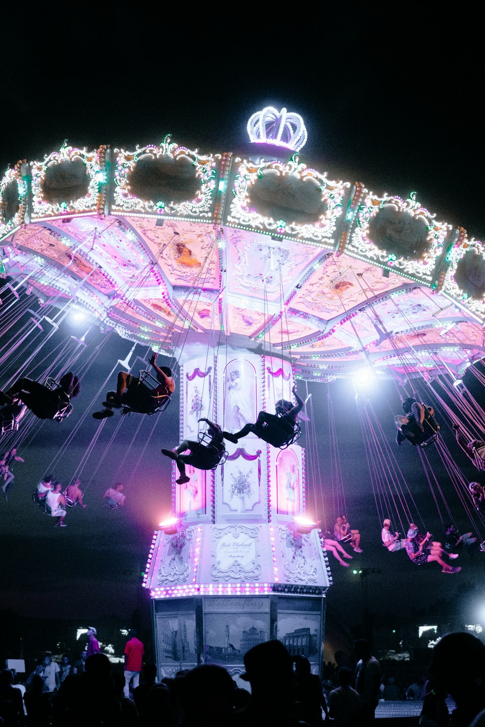 person riding carousel at night-time